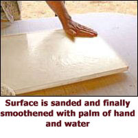 Surface is sanded and finally smoothed by palm of hand and water